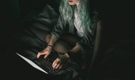 woman using laptop in the dark