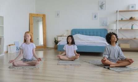 focused multiracial friends meditating in room